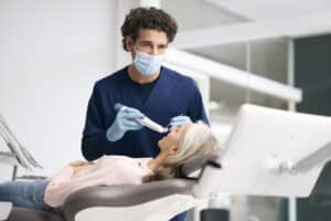 trios 6 lifetyle photos trios 6 male dentist scanning female patient move pro high res 2025
