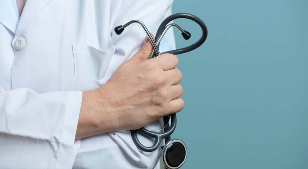 femme médecin avec stéthoscope sur fond bleu, ordre des médecins